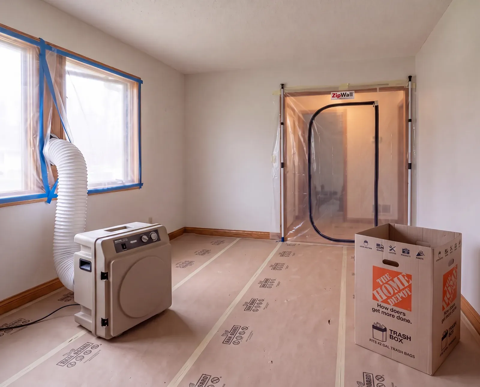 Sealed dust barrier and HEPA air scrubber running on an Enso kitchen job site in Austin